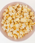 Bowl filled with Del's seasoned popcorn, ready to serve
