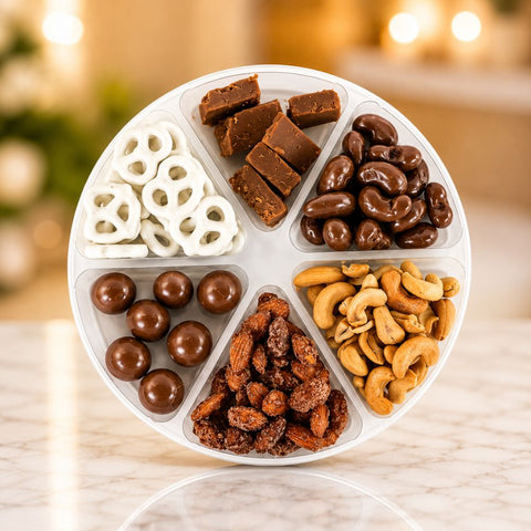 Celebration of Del's gourmet snack tray with six compartments of chocolate treats, roasted nuts, fudge, and frosted pretzels.