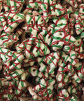Close-up of Christmas tree-pretzels cookies with red and green icing.