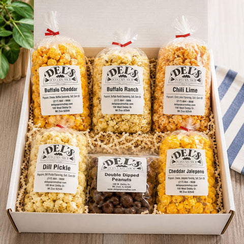 Assorted popcorn flavors in clear bags with visible labels in a box on a wooden surface - Father's Day Gift Box