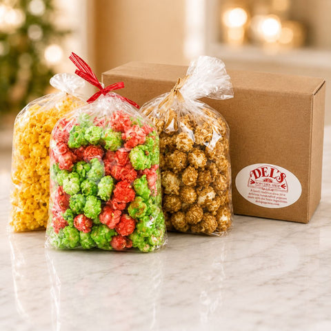 Del's Little Helper gift box with three bags of gourmet popcorn in assorted flavors displayed beside a Del's branded gift box.