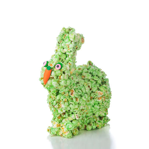 Green popcorn Easter bunny with orange nose and pink eyes on a white background