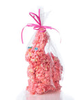 Pink popcorn bunny in a clear cellophane bag with a pink ribbon on a white background