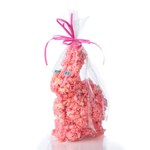 Pink popcorn bunny in a clear cellophane bag with a pink ribbon on a white background
