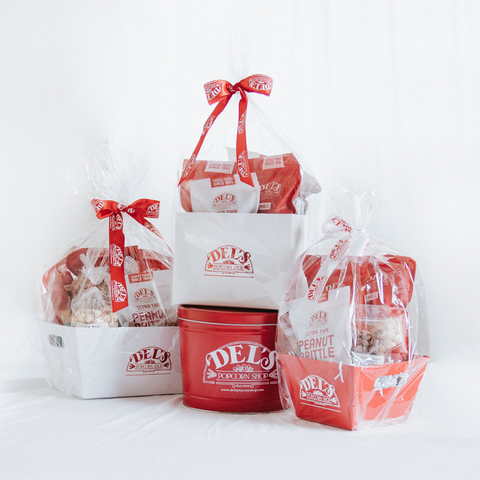 Del's Popcorn Shop gourmet gift collection featuring popcorn tins, snack boxes, and sweet & savory treats for any occasion
