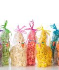 Colorful Easter popcorn bunnies with decorative ribbons on a white background