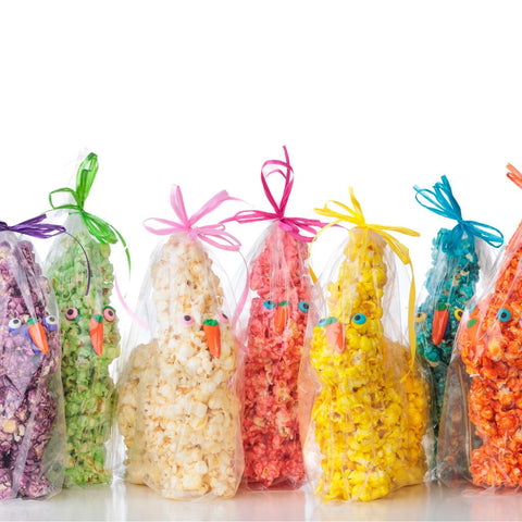 Colorful Easter popcorn bunnies with decorative ribbons on a white background